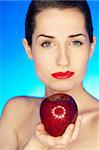 Portrait of beautiful woman with fresh red apple