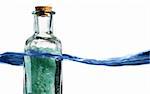 Bottle of bath salts sitting in a blue wave of water.