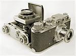 Two antiquarian 35-mm film cameras with put-forward lens.