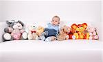 Portrait of cute baby with plenty of toys