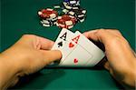 Two aces in hand in game poker on the green casino table