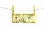 10 us dollar banknote hanging on a rope over white