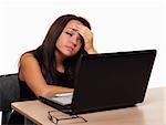 Attractive young brunette woman in business suit leaning on hands sitting at a desk looking bored or depressed