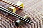 Two sets of wooden chopsticks on rests close up