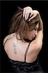 Tattoo on a back of the young woman