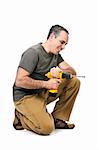 Kneeling handyman pushing on his cordless drill