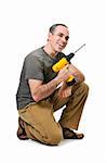 Kneeling happy handyman with his cordless drill