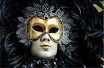 Carnival in venice with model dressed in various costumes and masks - black man