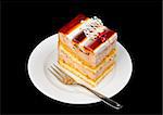 piece of fancy cake with jelly on top, isolated on black