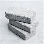 A stack of pumice stones against a white background.