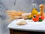 dough, rolling-pin, olive oil tomatoes, oregano and garlic