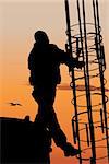 Vector silhouette of construction worker against sunset sky