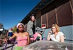 Portrait of three trashy women outdoors