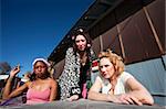 Portrait of three trashy women outdoors