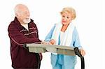 Handsome senior man trying to pick up a pretty woman on a treadmill.  She is ignoring him.  Isolated.