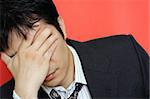 A stressed out businessman having a headache
