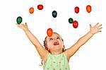 Happy shouting little girl welcoming the falling easter eggs - isolated, without motion blur