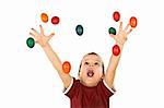 Happy boy shouting and reaching out for the falling colorful easter eggs - isolated, without motion blur