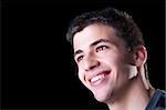 Portrait of a handsome young man smiling. Isolated on black background.