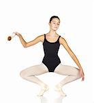 Young caucasian ballerina girl on white background and reflective white floor showing various ballet steps and positions. Full Plie in first Position.  Not Isolated.