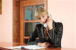 blond girl in Hotel reception talking at telephone