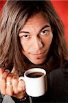 Closeup Portrait of a Handsome Young Man with Long Hair Drinking Coffee
