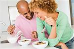 Husband And Wife Eating Breakfast Together