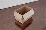 3d rendering of a cardboard box in a empty room with dark wood floor