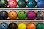 A rack of old worn bowling balls