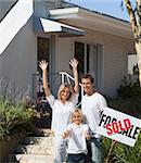 Family in front of House that they have just bought