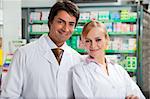 portrait of two pharmacists looking at camera and smiling