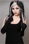 Pretty girl with goth hair in a vintage black dress