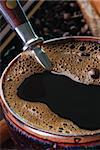 Close up of a mug with a coffee beans