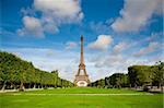 The Eiffel Tower in the morning with some clouds in the sky. Summer time