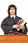 Angry female judge holding the books. Shallow depth of field