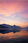 Beautiful sunrise over mountains, reflected on lake. Central Switzerland.