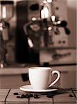 Preparing coffee with coffemaker in background