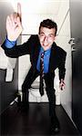 nice businessman standing in restroom with the finger up