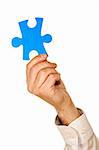 Businessman holding a piece of blue puzzle - isolated