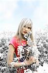 blond girl in a field between flowers with desaturate color