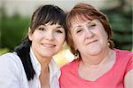 happy mother and daughter together in garden