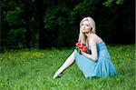 Pretty Female Sitting On The Green Meadow