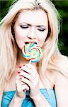 Woman Eating Lollipop. Close-Up Portrait