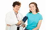 Friendly female doctor and her happy teenage patient, smiling as the doctor checks the girl's blood pressure.  Isolated.