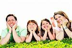 Portrait of happy family of four laying resting head on hands