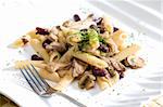 penne with pork pieces and champignons