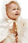 Laughing baby in baptismal clothes, isolated