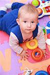 Portrait of cute newborn playing with toys
