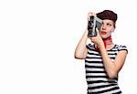 beautiful girl with red bandana, beret and striped shirt in a classic 60s french look holding a vintage 8mm substandard camera