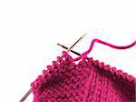 a pair of knitting needles and pink yarn